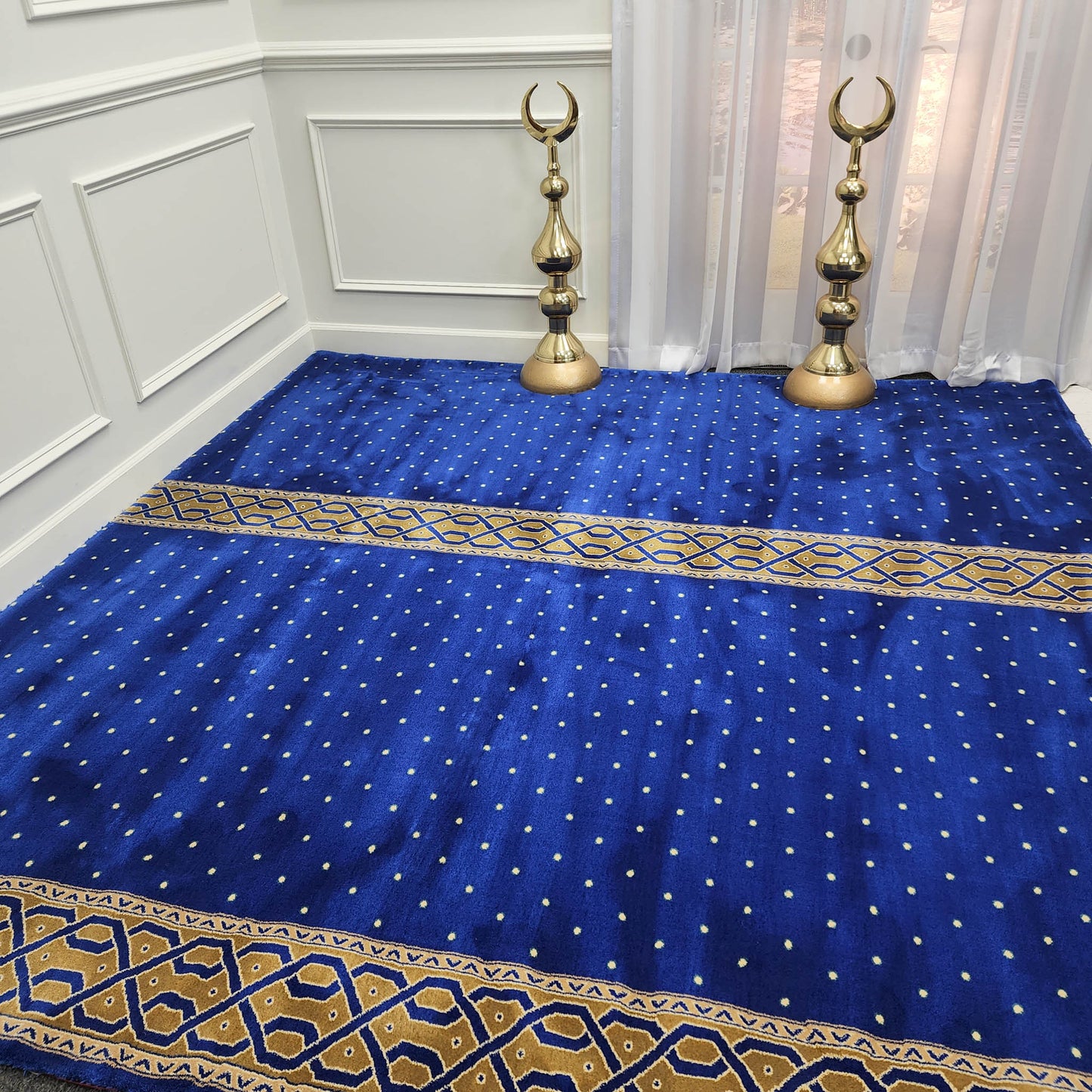 Navy blue mosque carpet with gold prayer lane.